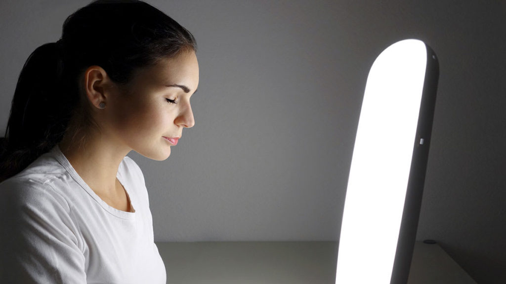 woman using light therapy