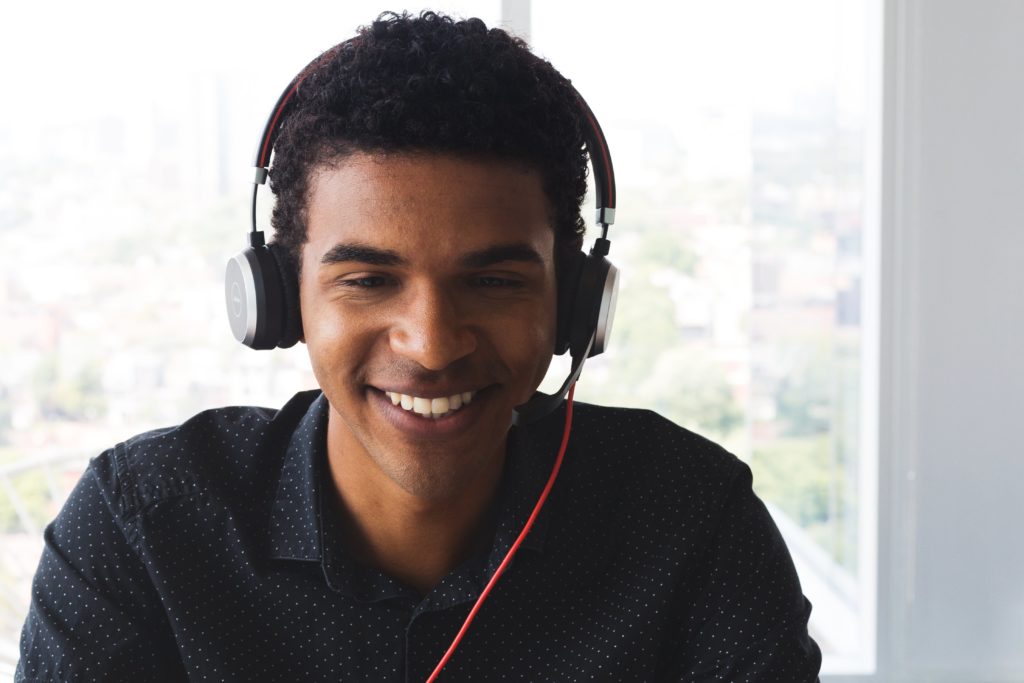 young black man wearing a headset and smiling